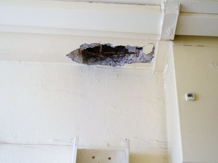 The writer is concerned that rusty steel reinforcement rods in his public housing block may lead to spalling concrete after further corrosion.