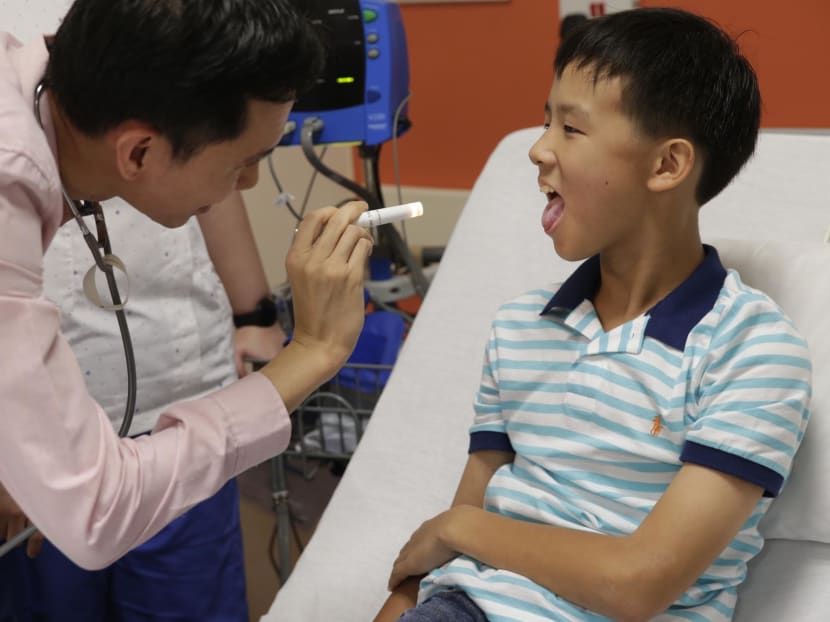 A doctor examines Tng Shih Kai during a check-up. Photo: Wee Teck Hian