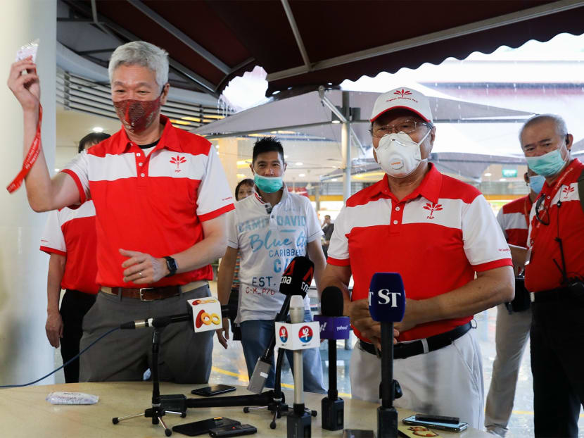 Dr Tan Cheng Bock (front row, right) presented a party membership card to Mr Lee Hsien Yang (front row, left) during a Progress Singapore Party breakfast meeting at Tiong Bahru Market on June 24, 2020.