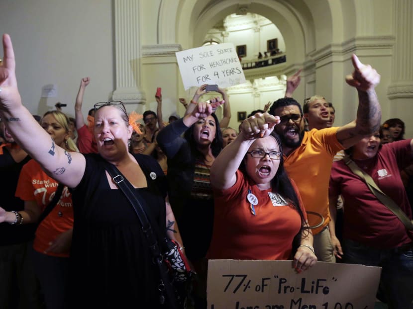 Opponents of HB 2, an abortion bill, yell outside the Texas House after the bill passed, Tuesday, July 9, 2013, in Austin, Texas. Photo: AP
