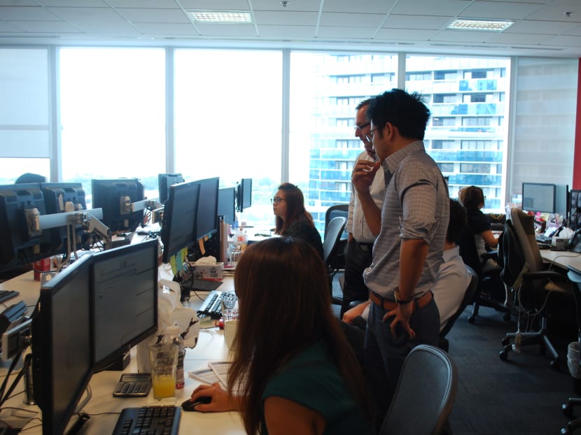 Traders at the floor of the Singapore office of IG. Photo: Angela Teng