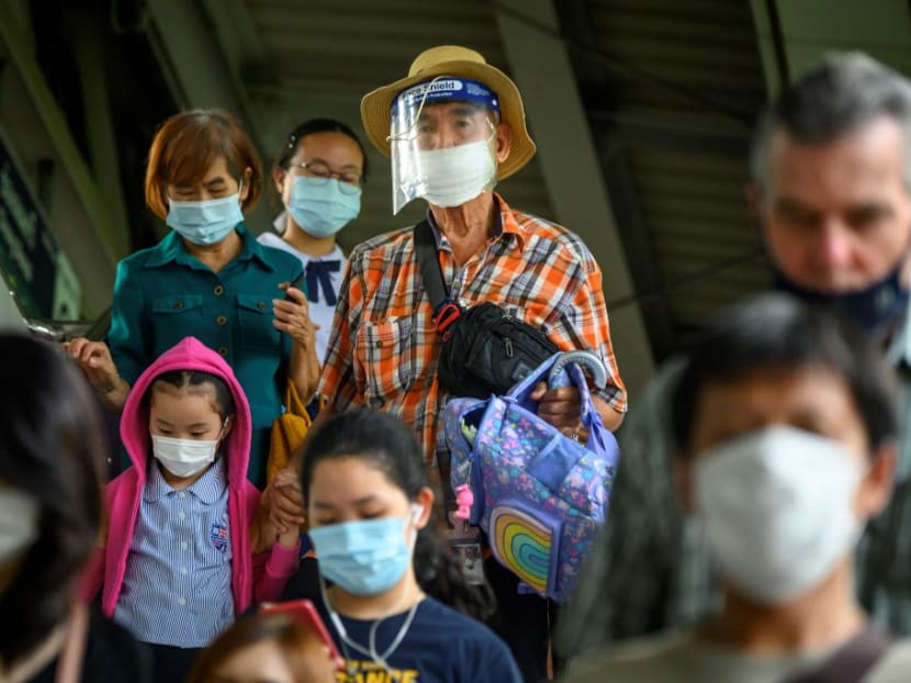 Passengers wearing face masks as a preventive measure against the spread of Covid-19 walk out of a commuter train station in Bangkok. Passengers wearing face masks as a preventive measure against the spread of Covid-19 walk out of a commuter train station in Bangkok.