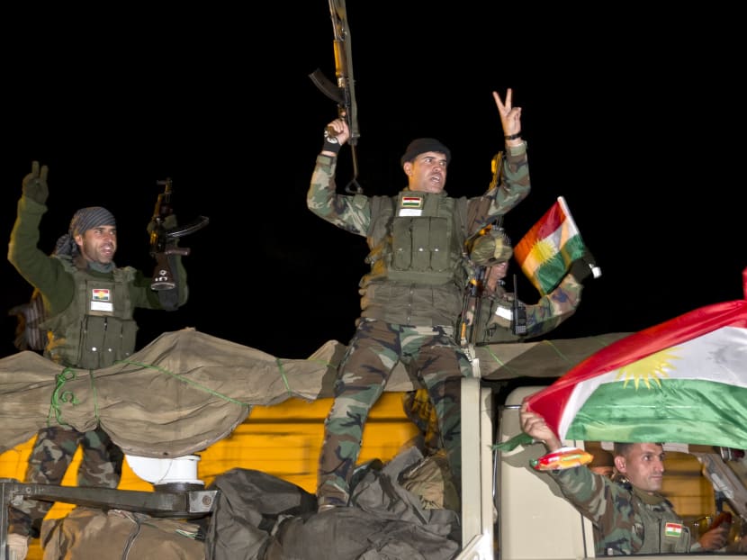 Iraqi Kurdish peshmerga fighters cheering. Photo: AP