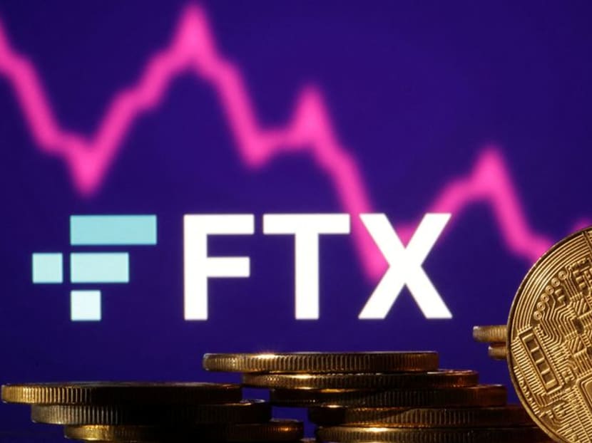 Representations of cryptocurrencies are seen in front of displayed FTX logo and decreasing stock graph in this illustration taken Nov 10, 2022.