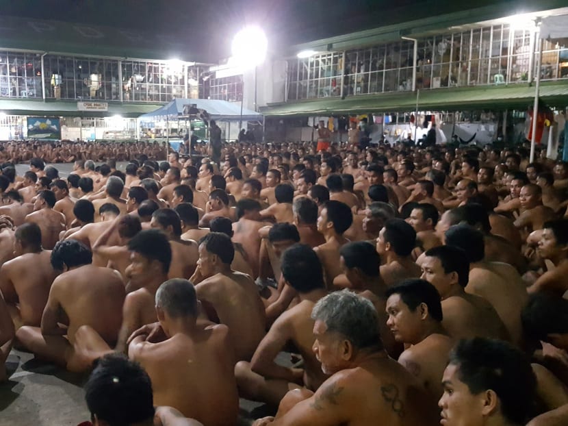 This handout from the Philippine Drug Enforcement Agency-Regional Office 7 (PDEA RO-7) taken on February 28, 2017 and released on March 2, 2017 shows naked inmates at the Cebu city jail sitting during a joint raid by the PDEA and the Cebu Police provincial office on illegal drugs and contraband. Photo via AFP
