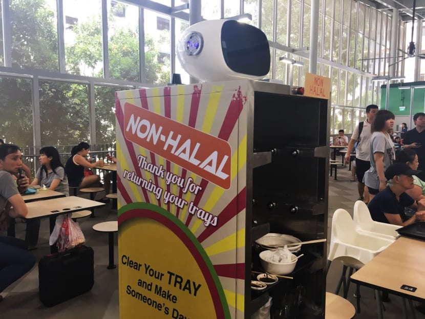 Roaming robots will be one of the new features of the newly-opened hawker centre at Jurong West Street 61, including an incentive to return used crockery and cutlery. Photo: Siau Ming En/TODAY