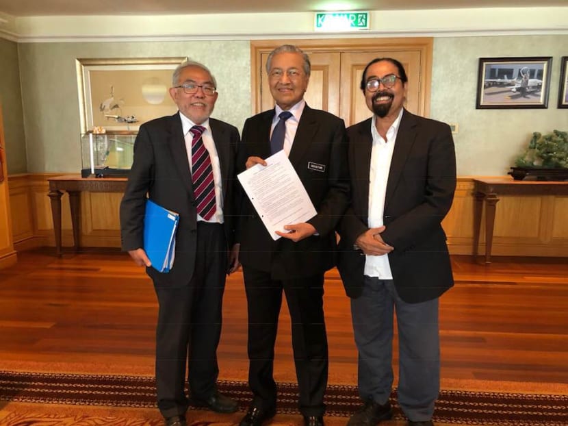Former political dissident Tan Wah Piow (L) and Malaysian activist Hishammuddin Rais pose for a picture with  Malaysian PM Mahathir Mohammad on Aug 30, 2018.