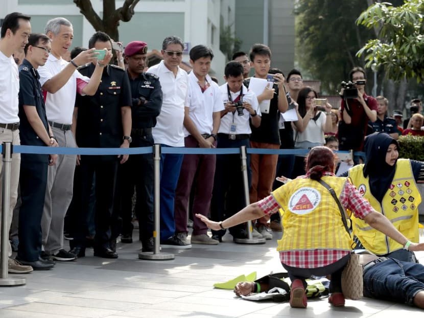 PM Lee taking a photo of Community Emergency Response Team volunteers attending to a ‘casualty’ during a simulated terrorist attack held during Teck Ghee’s Emergency Preparedness Day on March 19, 2017. Photo: Jason Quah/TODAY