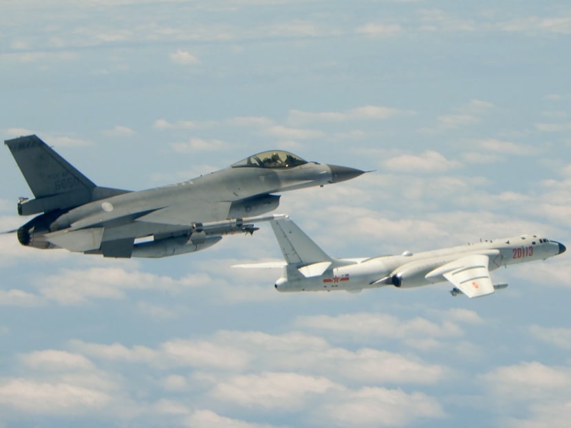 A file photo of a Republic of China (Taiwan) Air Force F-16 fighter aircraft (left) flying alongside a Chinese People's Liberation Army Air Force H-6K bomber on May 11, 2018. Taiwan's defence ministry began making the Chinese warplane incursions into the air defence identification zone  public in September 2020.