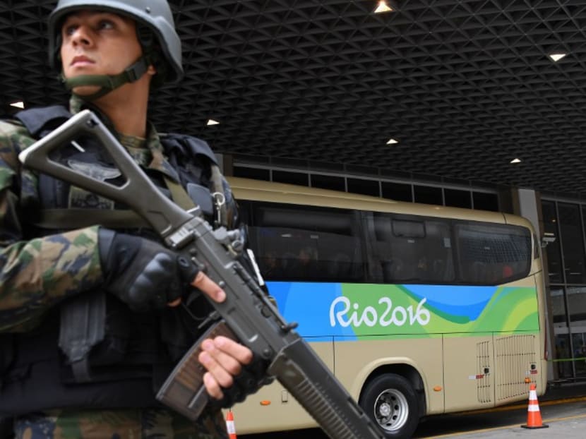 Security forces patrol the Antonio Carlos Jobim International Airport next to the US Olympic team bus in Rio de Janeiro, Brazil, on July 29, 2016. Photo: AFP