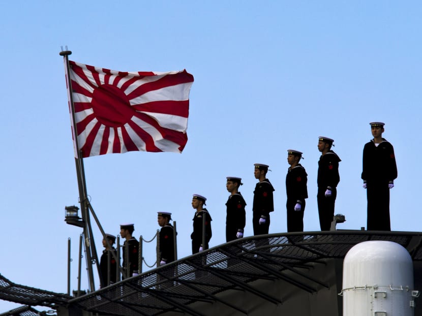 Sailors stand on the deck of the Izumo warship as it departs from the harbour of the Japan United Marine shipyard in Yokohama, south of Tokyo in this March 25, 2015 file photo. Photo: Reuters