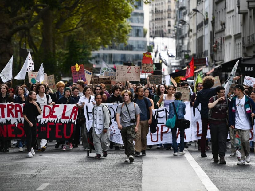 Protestors walk during a Youth For Climate demonstration in Paris, on Sept 25, 2022.