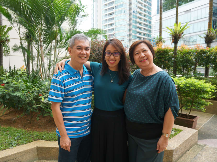 Autoimmune encephalitis survivor Deborah Yap, 28, with her parents Agnes Goh, 59, and Patrick Yap, 64. Photo: NNI