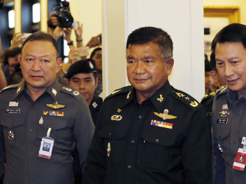 Senior adviser to the Royal Thai Army Lt. Gen. Manas Kongpaen ,center ,arrives at the police headquarters in Bangkok, Thailand Wednesday, June 3, 2015. Photo: AP
