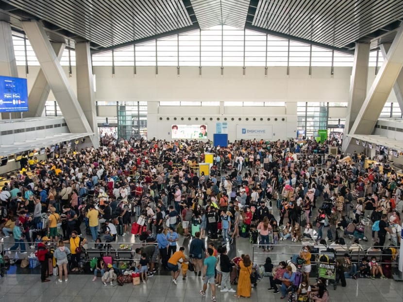 Stranded assengers wait for information about their flights at terminal 3 of Ninoy Aquino International Airport in Pasay, Metro Manila on Jan 1, 2023.