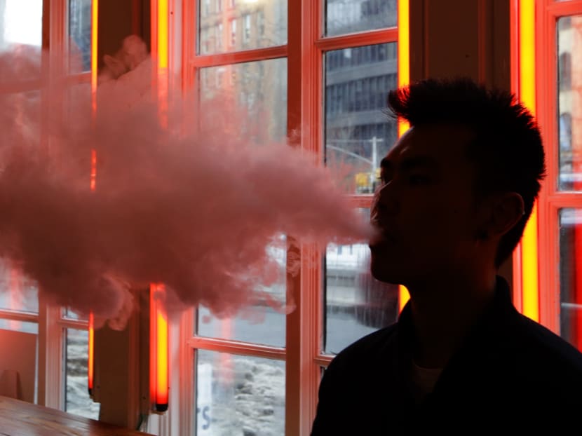 A patron exhales vapour from an e-cigarette at the Henley Vaporium in New York on Feb 20, 2014. Photo: AP
