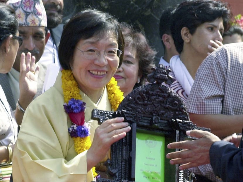 Junko Tabei, the first woman to summit Mount Everest in 1975, receives a gift from Katmandu city official during ceremonies on May 27, 2003, in Katmandu, Nepal. Photo: AP