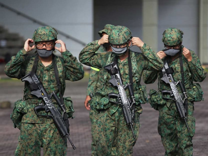 Recruits putting on their masks during a training session at BMT Centre on Pulau Tekong, Oct 1, 2020.