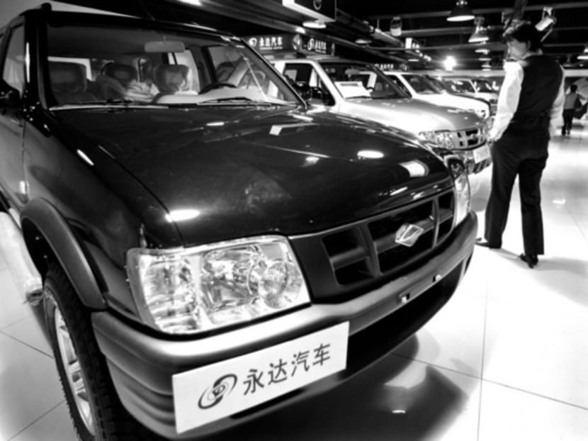 A Chinese visitor looking at models of Chinese SUV Landwind at a showroom in Shanghai. In the first half of this year, sales of Chinese-branded SUVs rose roughly 30 per cent versus 12 per cent for foreign names. From January to June, six of China’s 10 best-selling SUVs were domestic. Photo: Reuters