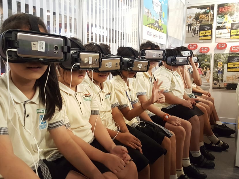Students from Zhangde Primary School try out 'IM Road Safety Savvy', an initiative which uses Virtual Reality (VR) to help children learn road safety skills in an engaging and fun way. Photo: Joey Chua