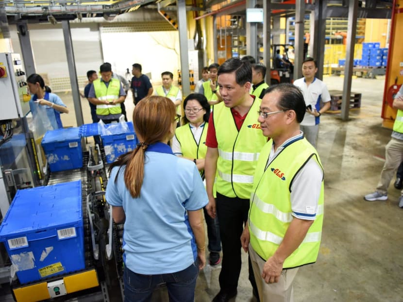 Minister for Trade and Industry Chan Chun Sing (second from right) visiting NTUC FairPrice's Benoi Distribution Centre in Joo Koon on Saturday (March 7, 2020). With him is FairPrice group CEO Seah Kian Peng (right).