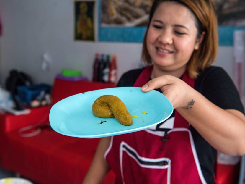 This picture taken on June 19, 2017 shows Wilaiwan Mee-Nguen showing off a dessert in the shape of dog poop that she prepared at her home in Bangkok. It might turn some stomachs, but a dessert-maker in Thailand has been flooded with orders ever since she started crafting gelatinous sweets into the shape -- and colour -- of dog poop. Photo: AFP