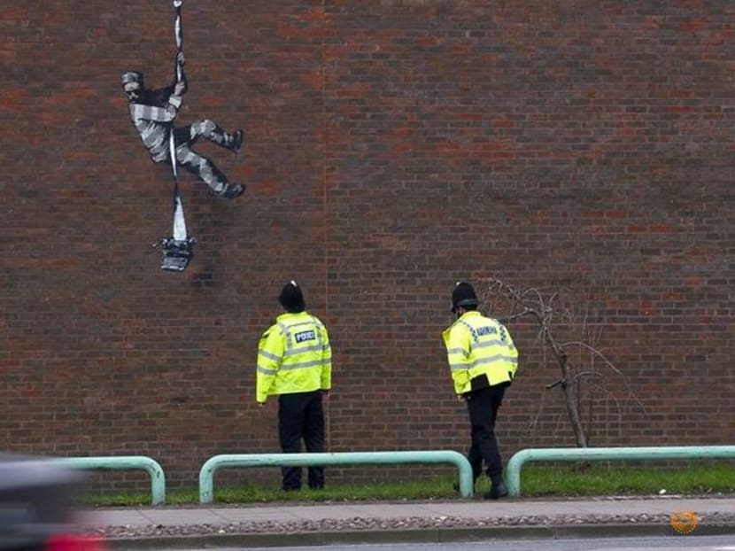 Banksy at work: Black hoodie, head torch, paint and freedom Banksy at work: Black hoodie, head torch, paint and freedom