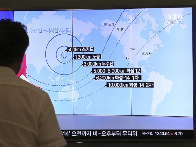 A man watches a TV screen showing a local news programme reporting on North Korea's missiles. Photo: AP