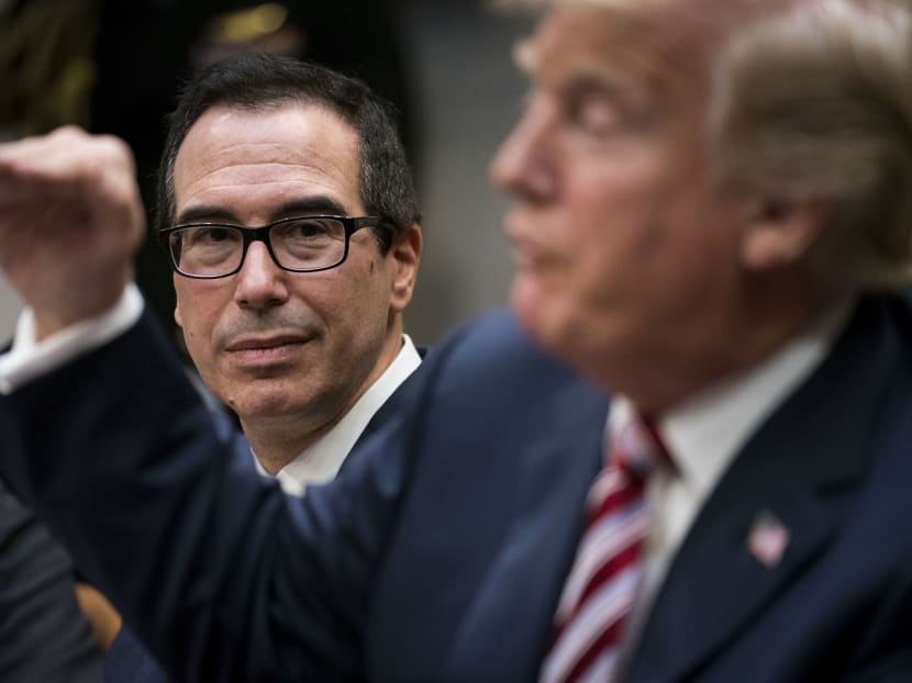 US Treasury Secretary Steven Mnuchin (L) looks on as President Donald Trump gestures during a meeting in the White House. Mr Mnuchin says the US is discussing rejoining the Trans-Pacific Partnership, more than a year after Mr Trump abruptly pulled the US out of the trade pact. Photo: The New York Times