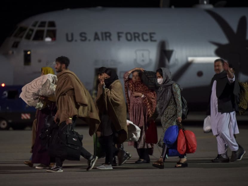 Afghan refugees, fleeing the Afghan capital Kabul, exit an US air force plane upon their arrival at Pristina International airport near Pristina on Aug 29, 2021. Kosovo has offered to take in temporarily thousands of Afghan refugees evacuated by US forces from Kabul until their asylum claims are processed.