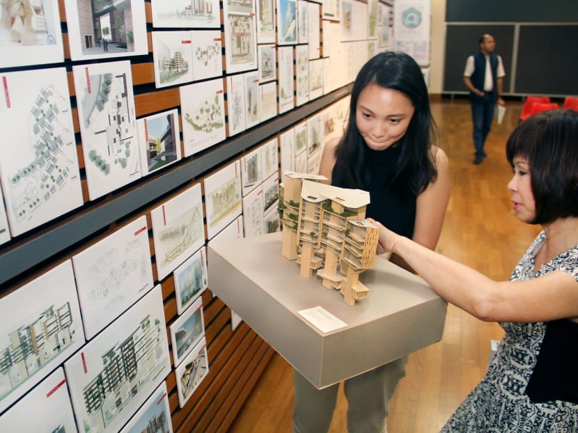 Sarah Ng, a NUS Architecture Masters graduate showing Dr Amy Khor, Senior Minister of State, Ministry of Health and Ministry of Manpower her model of a nursing home design suited for high-rise, high-density Asian cities which was done in her third year. Photo: Geneieve Teo