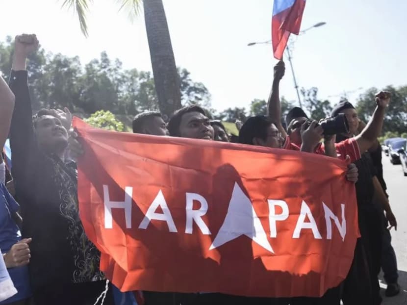 Supporters holding Pakatan Harapan flags cheering PKR MPs who arrived at Istana Negara in an open-top tour bus on Feb 26, 2020.