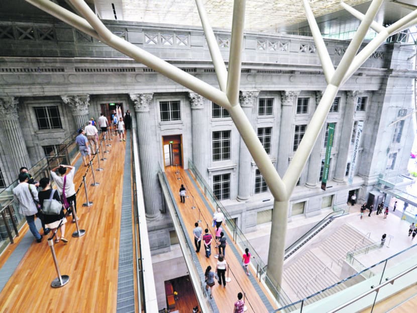 Visitors crossing the link bridges at connecting the former Supreme Court and Cityhall sections at the National Gallery Singapore. Photo: Robin Choo