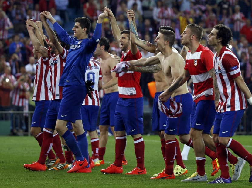 Atletico Madrid players react after winning their Champions League quarter-final second leg soccer match against Barcelona, in Madrid, April 9, 2014.  Photo: Reuters