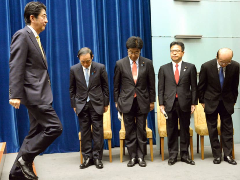 Japanese Premier Shinzo Abe (left) leaving a press conference at his office in Tokyo on May 15, 2015, after his Cabinet passed the security Bills. Photo: Kyodo