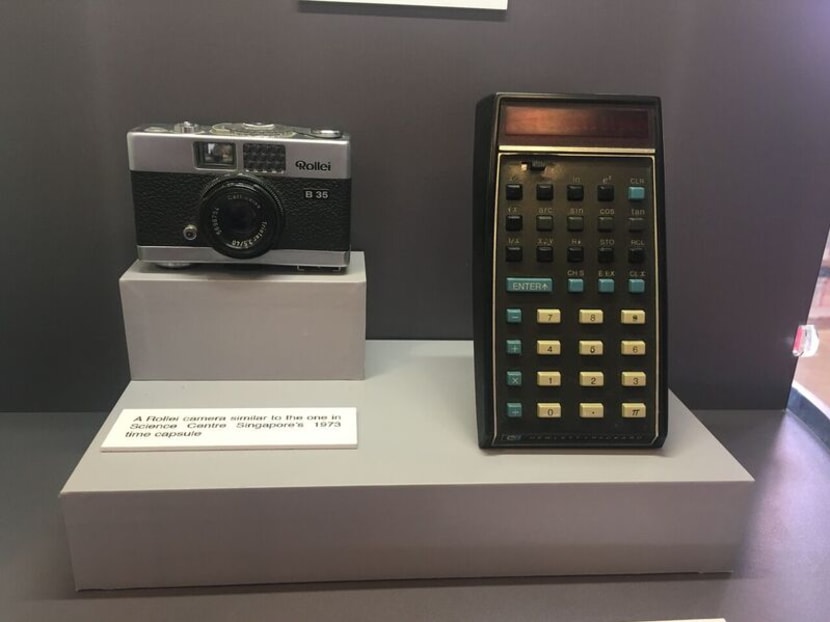 A 35mm Rollei camera (left) and a HP-35 scientific calculator from the 1970s. The Frozen in Time: Time Capsules in Singapore exhibition will remain at Toa Payoh Public Library till the end of November, and will travel to seven other public libraries until November next year. Photo: Louisa Tang/TODAY