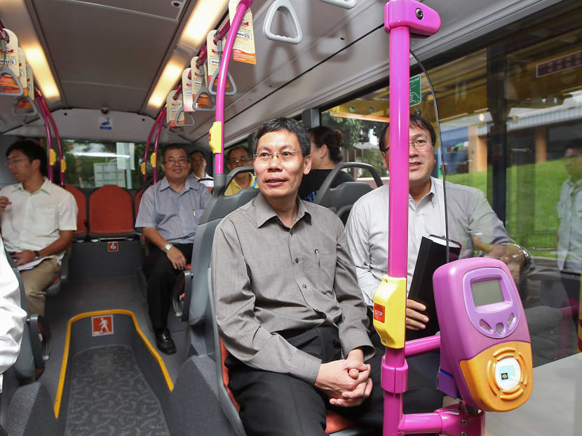 Mr Lui (in grey shirt) onboard a bus in December 2012. The Transport Minister, who entered politics in 2006, is leaving his post and the party before the upcoming General Election that could be held as early as next month. TODAY File Photo