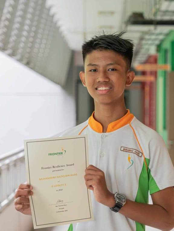 Muhammad Haziq Alias with his Frontier Resilience Award. Muhammad Haziq Alias with his Frontier Resilience Award.