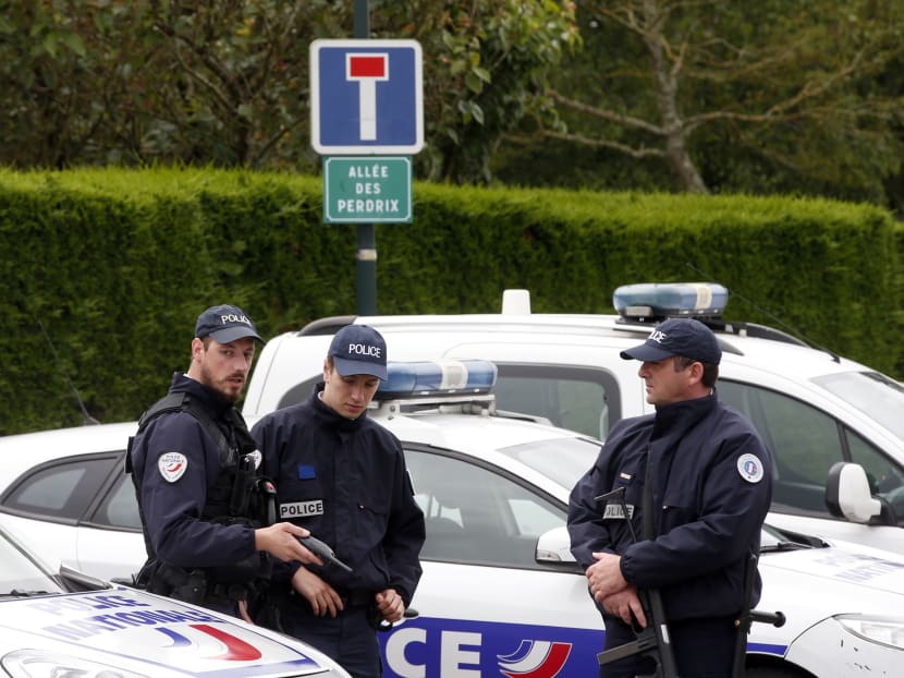 French police officers block the road leading to a crime scene the day after a knife-wielding attacker stabbed a senior police officer to death on Monday evening (June 13) outside his home in Magnanville, west of Paris, France. Photo: AP