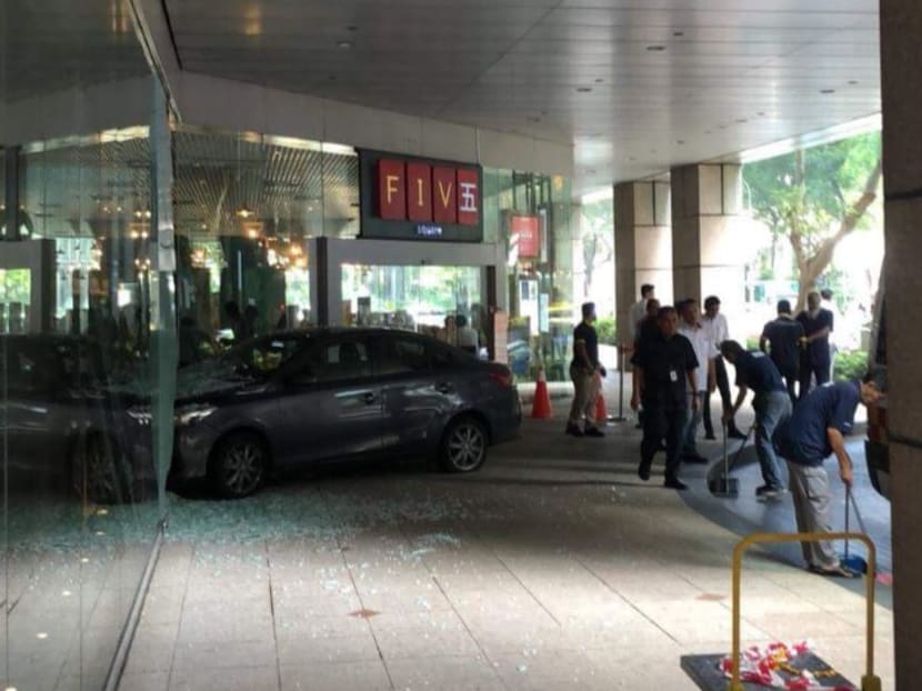 A car is seen turning into the drop-off point of the building when it mounted the kerb before it smashed into the glass facade of Five Square bar.