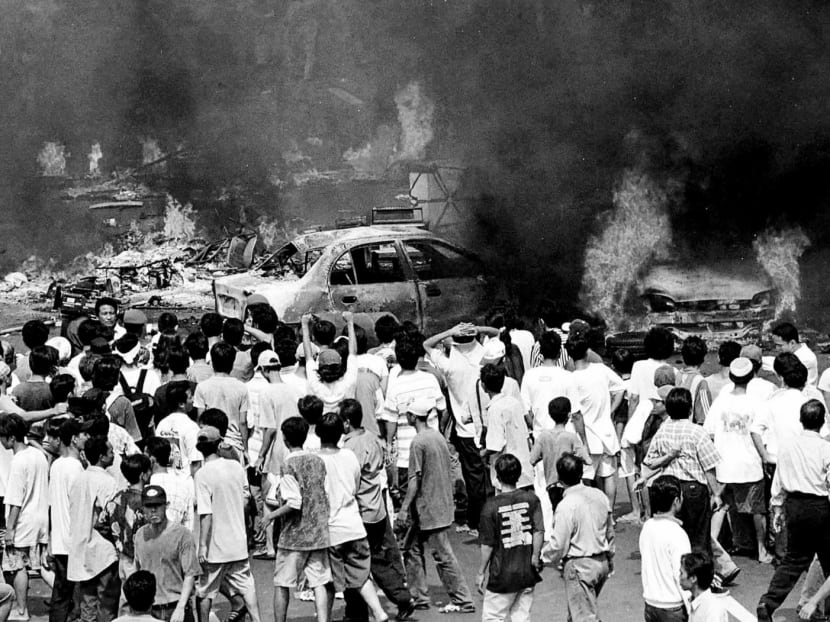 Rioting mobs surround burning vehicles in central Jakarta May 14, as the capital is ravaged by its most savage rioting in three decades May 14, in a massive outpouring of discontent [against ageing President Suharto] . Police and troops fired fired off warning shots but there was no apparent slackening of rampant violence a day after 12 people were killed in anti-government protests, riots, arson and looting.