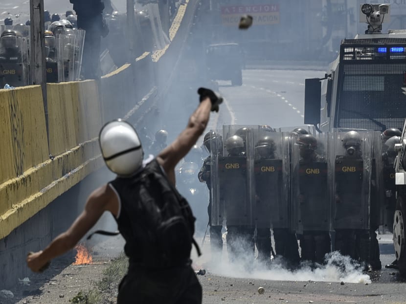 Venezuelan protesters hit the streets armed with "Poopootov cocktails," jars filled with excrement, which they vowed to hurl at police as a wave of anti-government demonstrations turned dirty. Photo: AFP