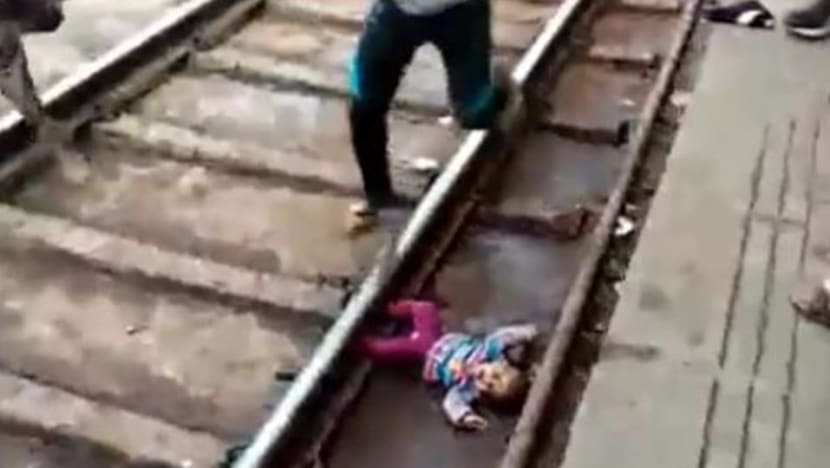Baby unscathed after falling onto train tracks in India Baby unscathed after falling onto train tracks in India