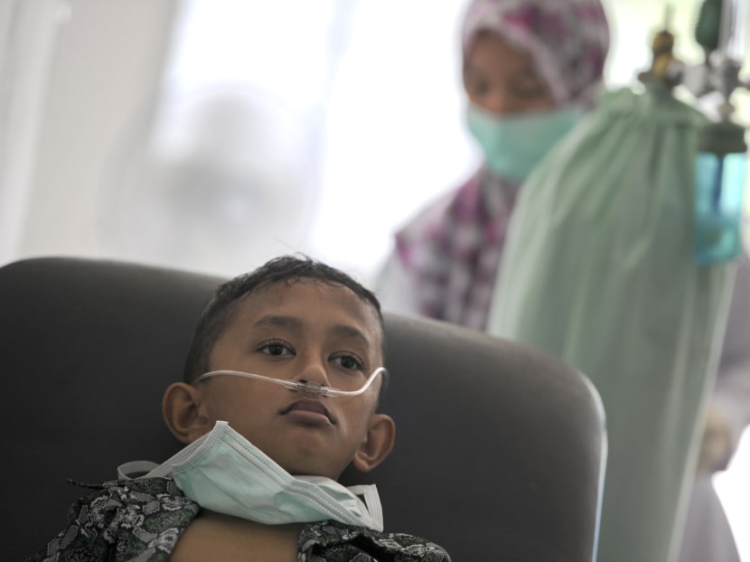 An Acehnese boy undergoes treatment for lung infection from thick smoke due to peat forest fires in Meulaboh, Aceh province on July 26, 2017. Indonesia's disaster mitigation agency (BNPB) has warned of an escalating threat of forest fires with the dry season expected to peak in coming months, while hot spots detected in the province of Aceh have already been causing choking smoke. Photo: AFP