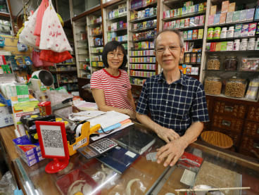 Mr Chong Leong Thye of Han Seng Thye Medical Products Trading, with his wife Wong Sai Moy, in their shop in Hougang, on May 24, 2022.