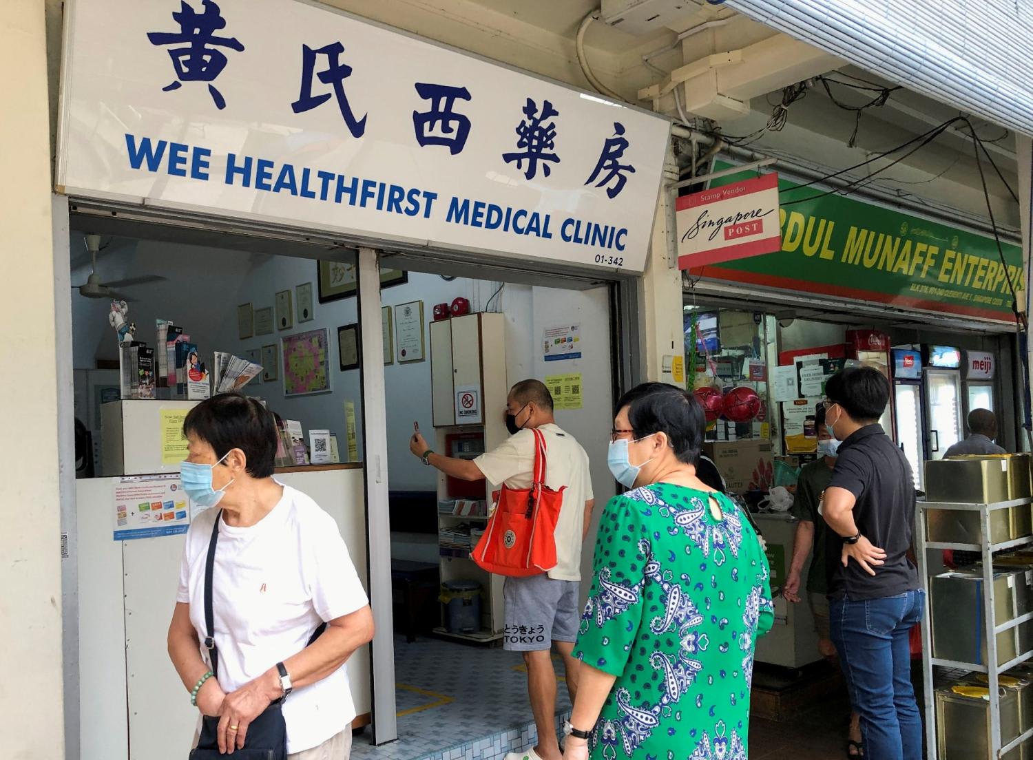 People waiting outside a general practitioner clinic in Clementi. People waiting outside a general practitioner clinic in Clementi.