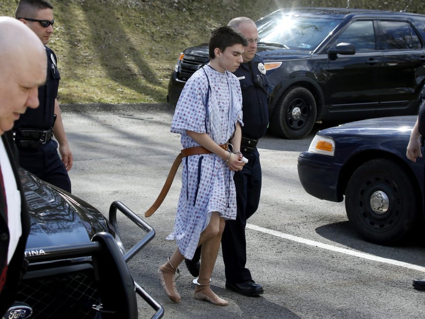 Alex Hribal, the suspect in the multiple stabbings at the Franklin Regional High School is escorted by police to a district magistrate to be arraigned on April 9, 2014. Photo: AP