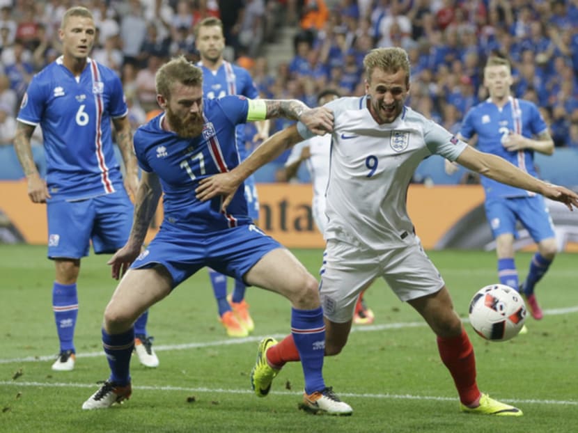 Iceland’s (in blue) victory against England produced several lessons for Singapore. Reputations do not guarantee success, and our players should work harder and focus more on teamwork to improve. Photo: AP