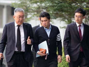 Ken Lim (centre) arriving at the State Courts on May 10, 2024.