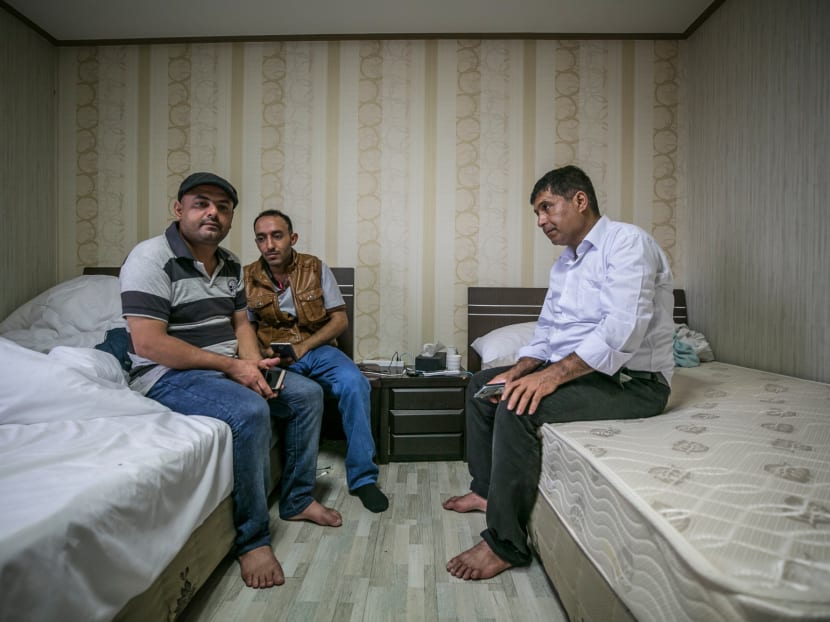 Mr Omar Hassan (left), Mr Abdo Ahmed (centre), and another refugee in a hotel room on South Korea's Jeju Island. About 30 Yemeni men are staying at the Olle Tourist Hotel, and according to one, immigration officials suggested they stay indoors as much as possible while their applications were being processed.